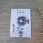 tarjeta con vela en forma de matera